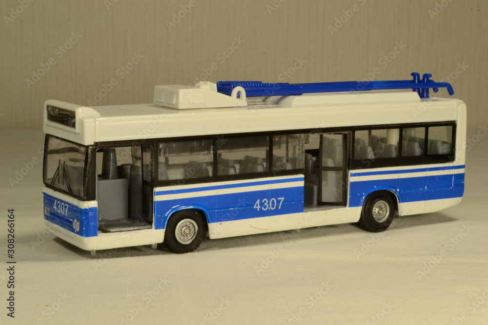 Children's toy, blue trolleybus with open passenger doors.