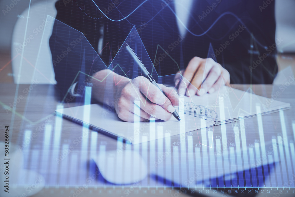 Forex graph on hand taking notes background. Concept of research. Multi exposure