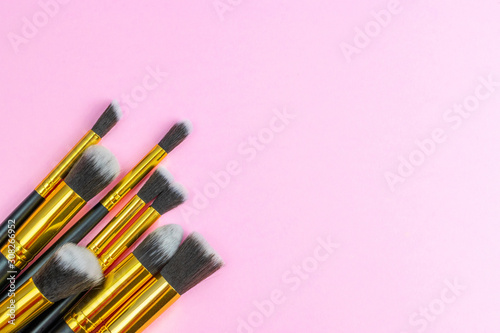 Fototapeta Naklejka Na Ścianę i Meble -  Makeup brush drawing. Cosmetic powder products isolated on pink