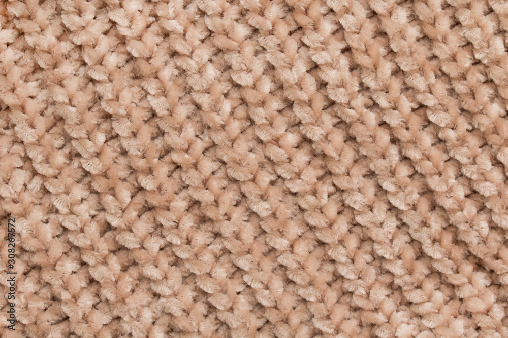 Fluffy tender baby beige fabric with waves and folds. Soft pastel textile texture. Folds on a soft cloth. Fluffy tender baby beige fabric with waves and folds. Soft pastel textile texture. Folds on a soft cloth.