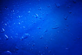 Water drop on metal surface in blue tone