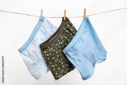 Male (boy) brief boxers hanging on the clothesline isolated on a white background