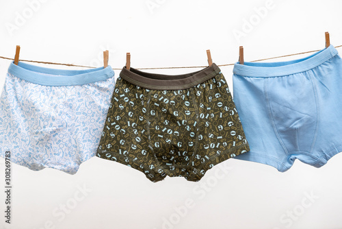 Male (boy) brief boxers hanging on the clothesline isolated on a white background