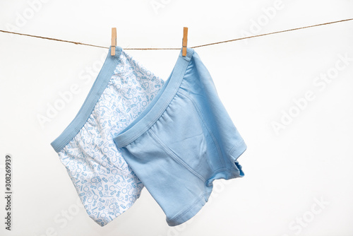 Male (boy) brief boxers hanging on the clothesline isolated on a white background