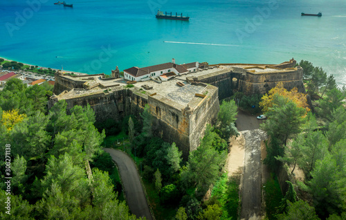 Aerial view of fortress Sao Felipe in Setubal Portugal, star shaped military base protecting the city and the harbor with bastions above the turquoise  water of the Atlantic ocean and the Sado estuary photo
