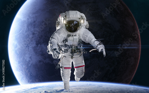 Fototapeta Naklejka Na Ścianę i Meble -  Astronaut on background of distant planets in deep space. Science fiction. Elements of this image furnished by NASA