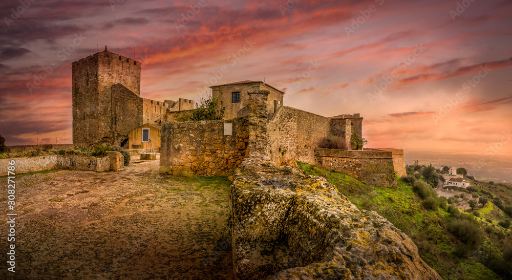 View of Palmela castle with dramatic sunset colorful sky near Setubal Portugal