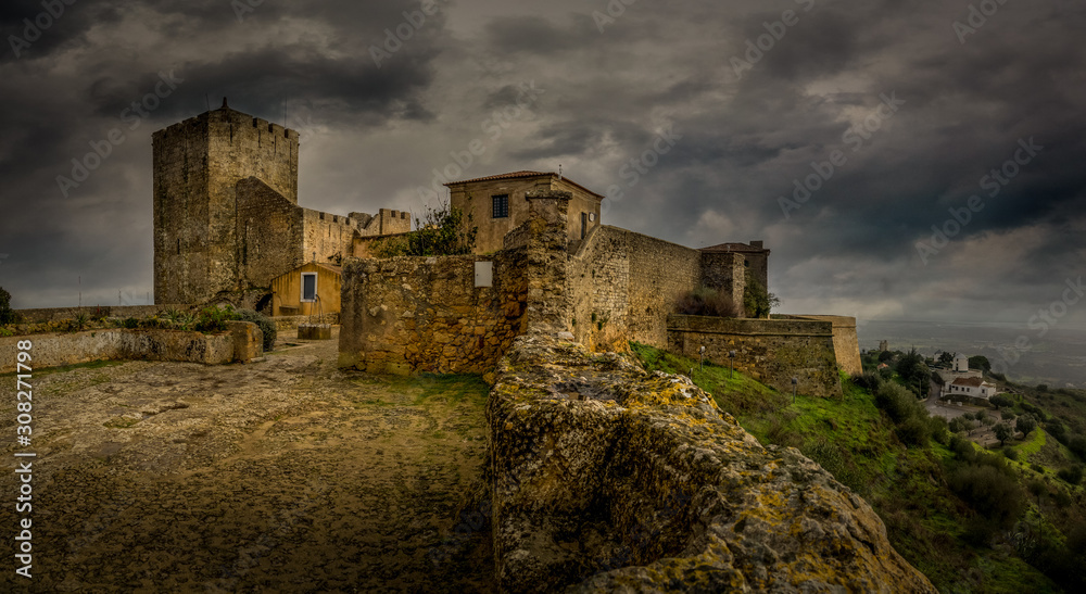 View of Palmela castle with dramatic sunset colorful sky near Setubal Portugal