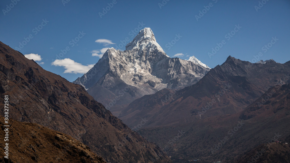 A mountain gorge. Mount Ama Dablam. Almost cloudless sky.