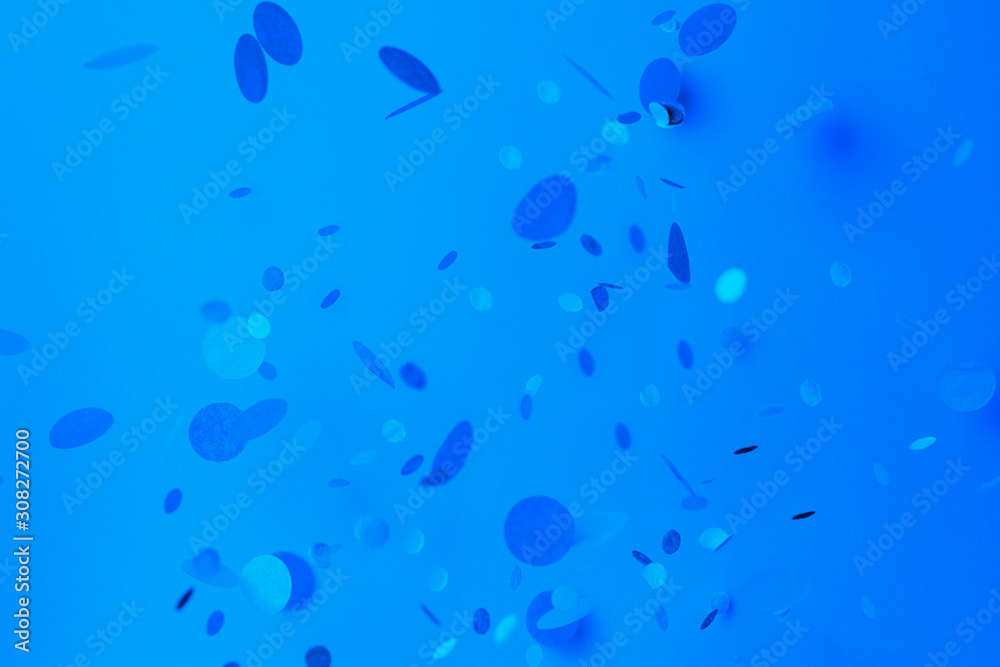 Blue confetti on blue background. Trendy classic blue tinting Blue confetti on blue background. Trendy classic blue tinting