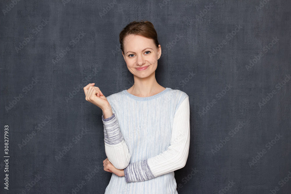 Portrait of happy satisfied young woman standing in relaxed position