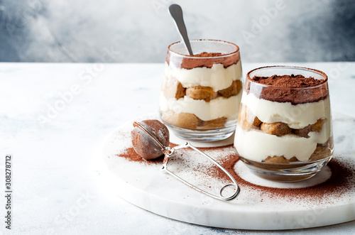 Traditional Italian dessert tiramisu in a glass. photo