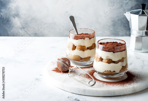 Traditional Italian dessert tiramisu in a glass.