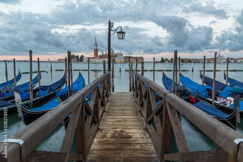 Gondolas docked at the pier in Venice