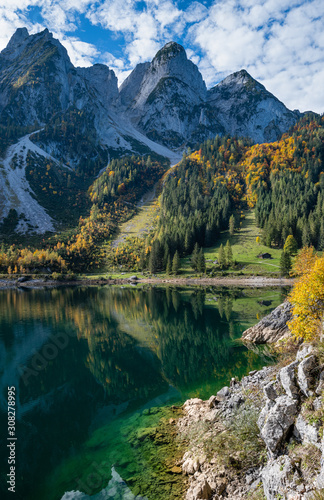 Autumn Alps mountain lake with clear transparent water and reflections. Gosauseen or Vorderer Gosausee lake  Upper Austria.