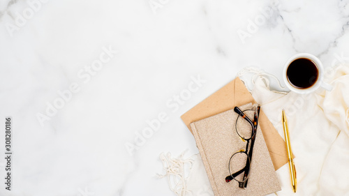 Stylish feminine accessories and office supply on marble background. Flat lay, top view. Beauty blogger workspace concept.