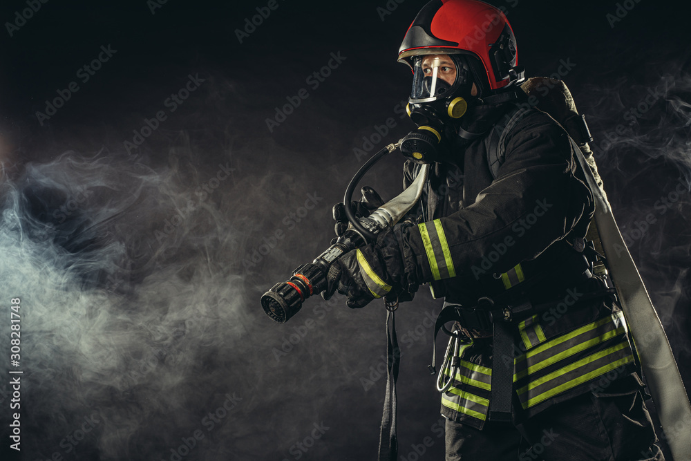 caucasian modern hero fireman in uniform don't afraid of danger, looking for people to save, using ropes, hammers and other equipment need for protection caucasian modern hero fireman in uniform don't afraid of danger, looking for people to save, using ropes, hammers and other equipment need for protection
