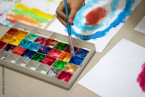 multiple color palette with hand hold brush for art work of kid or artist on workspace