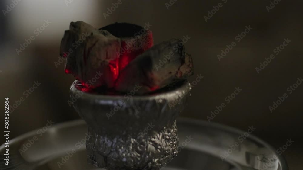 Hot ember on a hookah set lights up turning red when vaping. Hot ember on a hookah set lights up turning red when vaping.