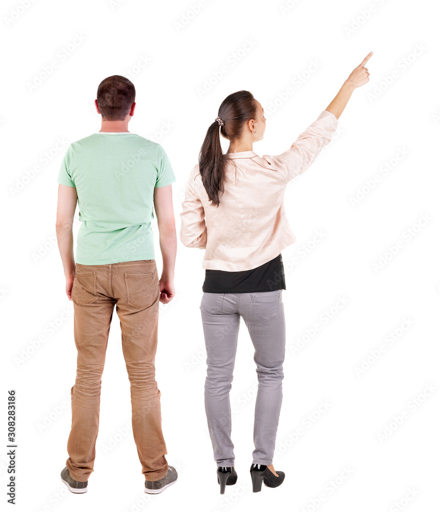 Back view of a stylish couple pointing. Back view of a stylish couple pointing.