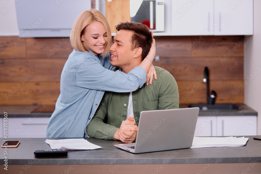 couple reading legal documents at home using modern laptop, family considering a mortgage or insurance, studying contract details, discussing conditions and looking at screen of laptop couple reading legal documents at home using modern laptop, family considering a mortgage or insurance, studying contract details, discussing conditions and looking at screen of laptop