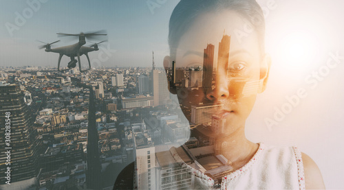 Foto Double exposure of businesswoman and cityscape with Drone quad copter with high resolution digital camera