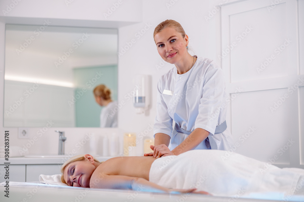 Smiling woman lying on relax massage table Smiling woman lying on relax massage table