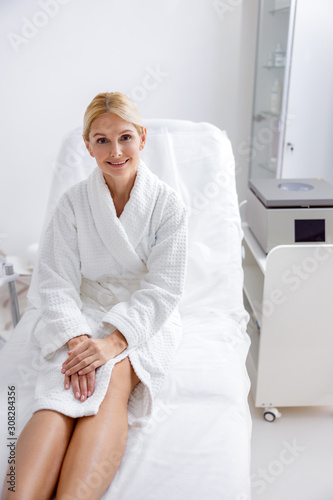 Smiling adult woman relaxing in beauty salon