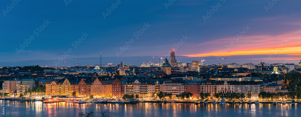 Stockholm, Sweden. Skyline View Of Residential Area Houses In Norr Malarstrand Street, Kungsholmen Island. Scenic View In Sunset Twilight Dusk Lights. Evening Lighting