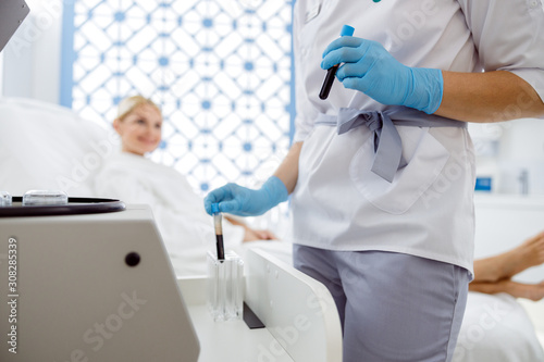 Woman watching the actions of a cosmetologist before the procedure