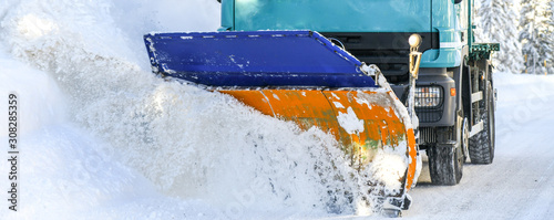 Sow plough truck removing fresh heavy snow from road in winter season detail. Maintenance cleaning vehicle.