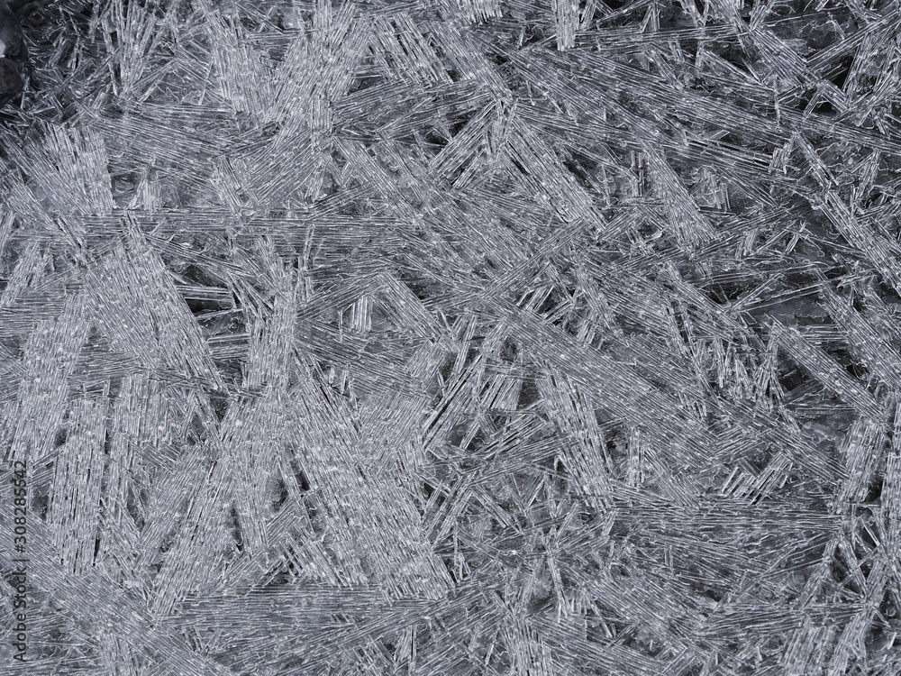 Crushed clear ice formation on the river shore. Background pattern close up