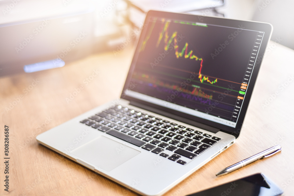 Modern laptop with financial bitcoin cryptocurrency crypto graph data trade. Computer notebook workplace detail. Modern laptop with financial bitcoin cryptocurrency crypto graph data trade. Computer notebook workplace detail.