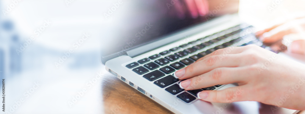 Business woman working on modern computer banner or panorama. Person buying online at internet. Laptop keyboard detail with hands copy space for text. Business woman working on modern computer banner or panorama. Person buying online at internet. Laptop keyboard detail with hands copy space for text.