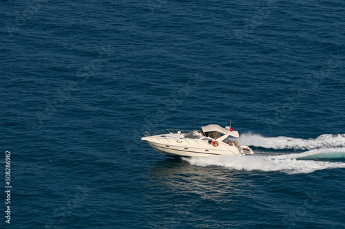 The speedboat traveling fast in the Mediterranean Sea and the trail it left behind © ali