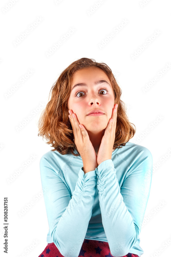 Cute young girl is looking surprised and funny. Teenager puts hands to her cheeks. Happy tween, isolated Cute young girl is looking surprised and funny. Teenager puts hands to her cheeks. Happy tween, isolated
