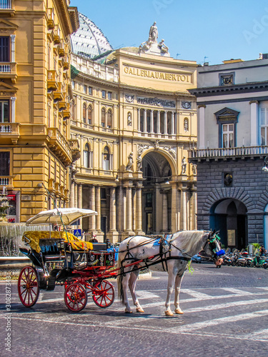 NAPLES, ITALY - AUGUST 17, 2011: Horse carriage in front of the Galleria Umberto I.