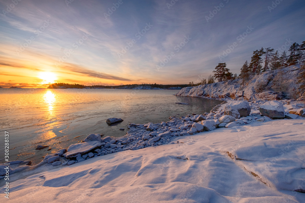  rocks and winter sunrise on the lake Ladoga island Kajosaari Republic of Karelia