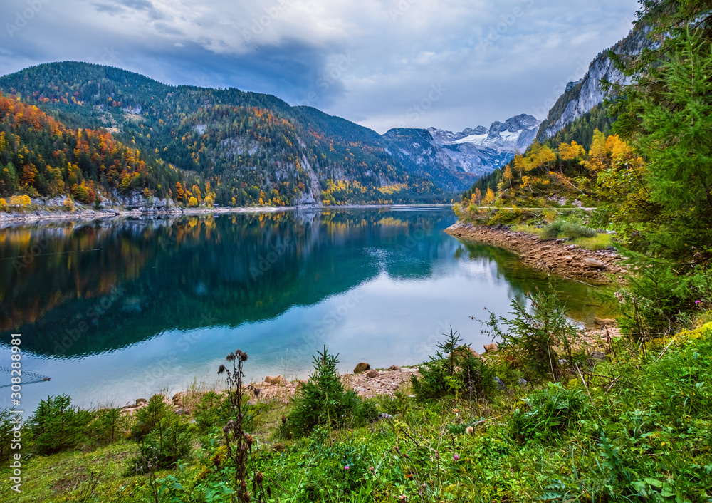 Gosauseen or Vorderer Gosausee lake, Upper Austria. Autumn Alps mountain lake with clear transparent water and reflections.