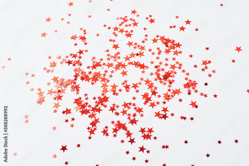 Abstract background with red confetti in shape of star on a white background