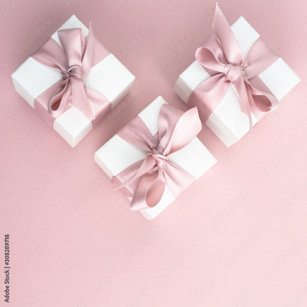 Gift boxes wiyh powdery ribbon. Powdery background. Silver bracelet with charms. Gift box for the New Year and Christmas. Best gift for Valentines Day and Mothers day. Gift boxes wiyh powdery ribbon. Powdery background. Silver bracelet with charms. Gift box for the New Year and Christmas. Best gift for Valentines Day and Mothers day.