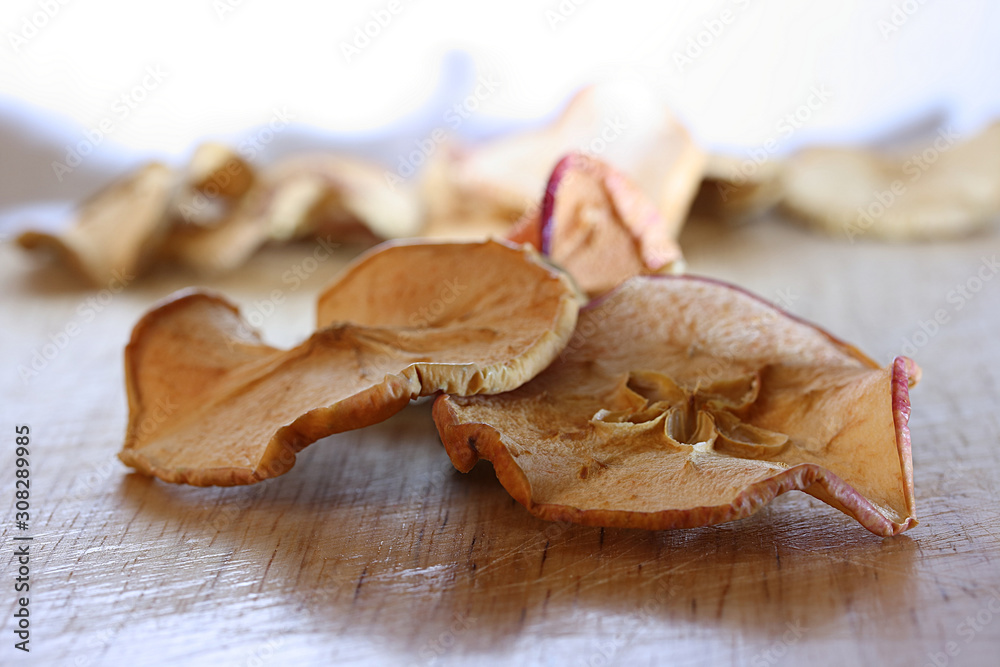 Fresh dried fruits from apples of various varieties on a wooden table Fresh dried fruits from apples of various varieties on a wooden table