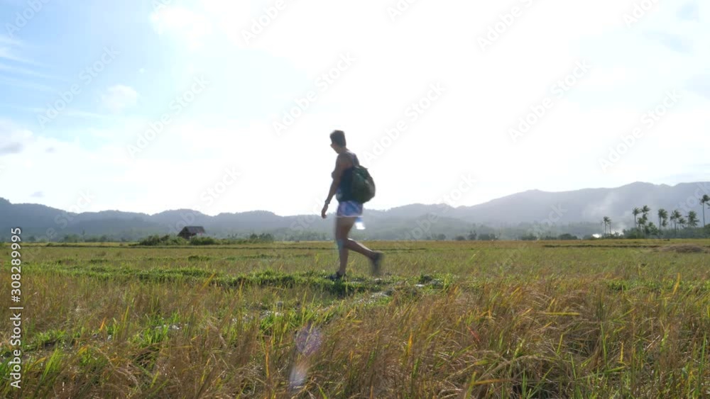 Asian woman walks trough rice fields in San Vincente, Palawan, Philipinnes Asian woman walks trough rice fields in San Vincente, Palawan, Philipinnes