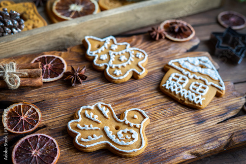 Christmas composition. Iceberg gingerbread, citrus sliced slices, Christmas tree branches, cinnamon sticks and starfish on wooden background.