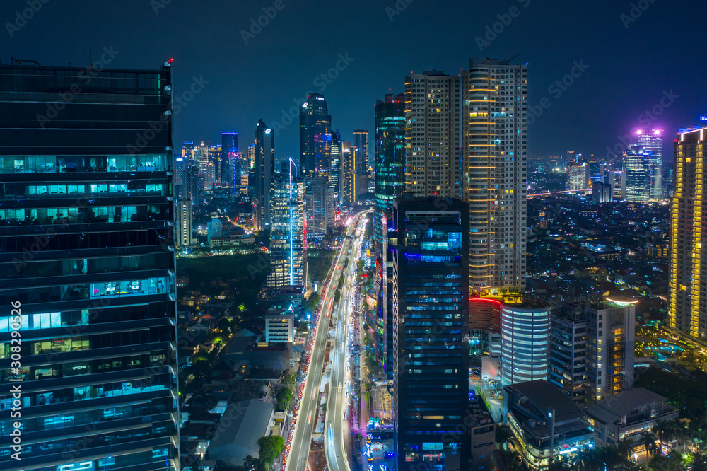 Aerial view of glowing buildings in hectic traffic Aerial view of glowing buildings in hectic traffic