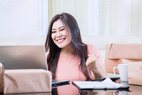 Asian woman giggling after finishing her jobs