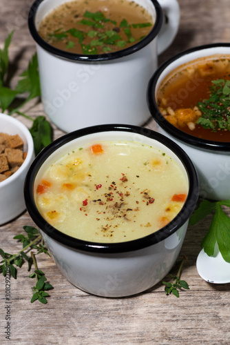 hot soups in mugs, vertical top view