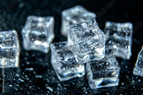 Ice cubes / melting ice cubes on black background, close up