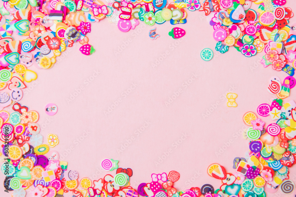 Different fimo slices on pink background. Copy space
