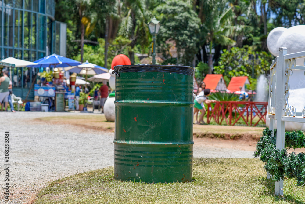 Old green metal barrels with party and few people. Old green metal barrels with party and few people.